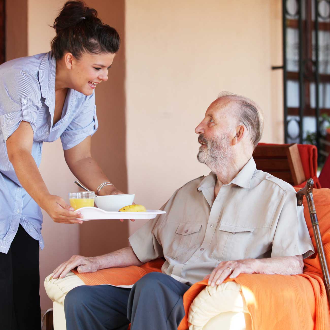 Live-in caregiver in Manhattan offering assistance to an older adult at home, demonstrating attentive 24-hour personal aide service with kindness and professionalism.