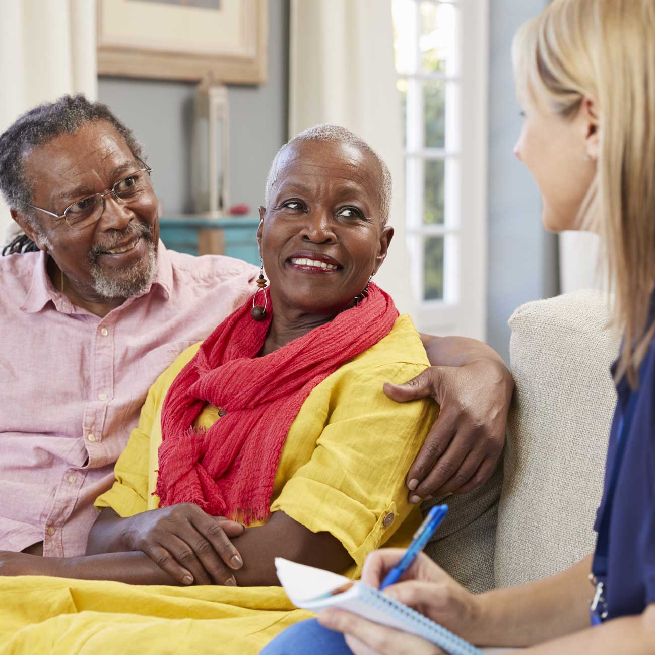 In-home care consultation in The Bronx, where a personal aide coordinator discusses companion care options with an elderly couple seeking reliable support in Manhattan, Queens, or Brooklyn.